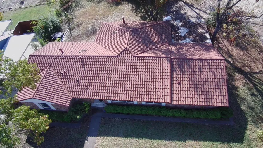 Aerial view of an aged tile roof before work begins