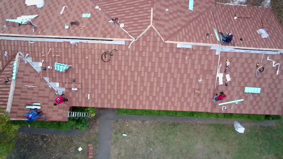 Drone view of a tile roof with new courses going down