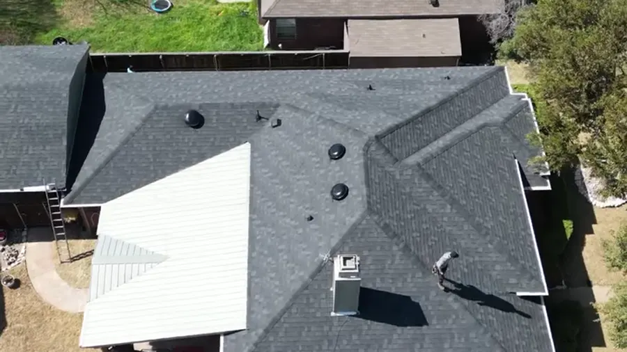 Drone view of a finished roof, chimney and backyard